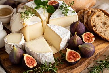Selezione di formaggi pugliesi con fichi e pane rustico su un tagliere